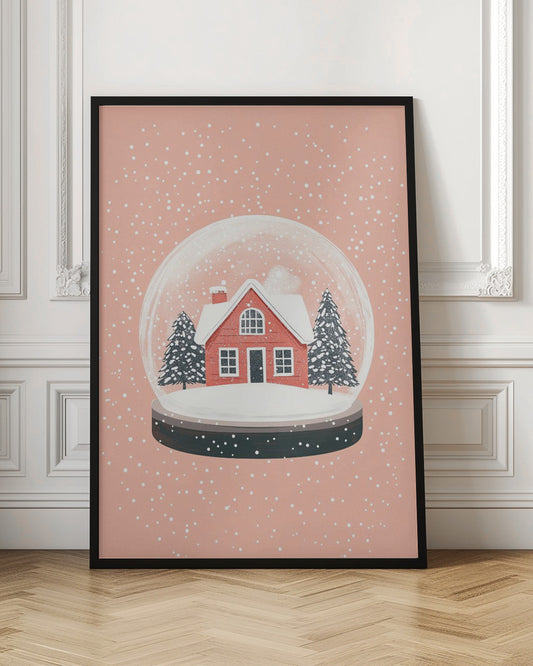 A charming illustration of a snow globe with a red house and two pine trees inside, all covered in snow. The snow globe is set against a soft pink background with white dots falling like snow, enclosed in a thin black frame. Poster