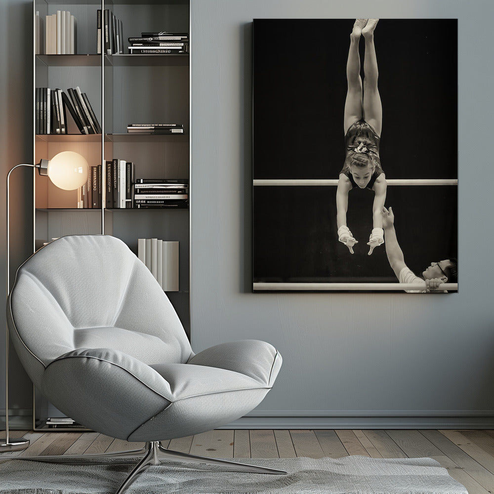 A dramatic black and white photograph of a young female gymnast performing a flawless handstand on the top of two parallel bars. Her body is perfectly vertical against a stark black background. Below, a male coach looks up at her with focused attention, his hand raised nearby, ready to spot her. Decor