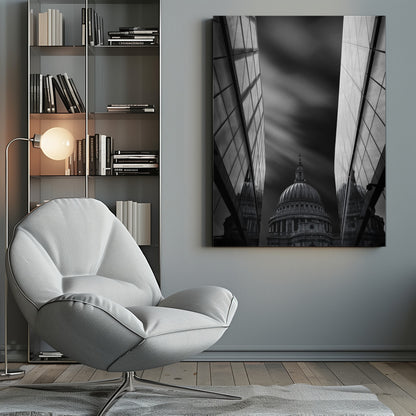A dramatic black and white, low-angle photograph of St. Paul's Cathedral in London, framed between two modern, reflective glass skyscrapers. A long exposure effect blurs the clouds in the sky, creating streaks of light and shadow behind the cathedral's dome. Poster