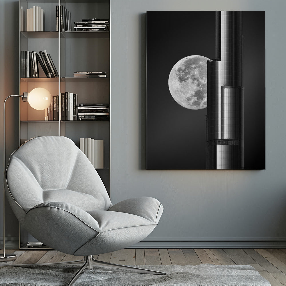 A dramatic black and white photograph of a massive full moon positioned next to a modern, towering skyscraper. The high-contrast image creates a striking juxtaposition between the natural celestial body and the man-made architectural marvel against a dark night sky. Poster