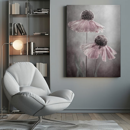 A soft-focus, artistic photograph of two delicate pink flowers with dark, textured centers and drooping petals against a muted, mottled grey background. Print