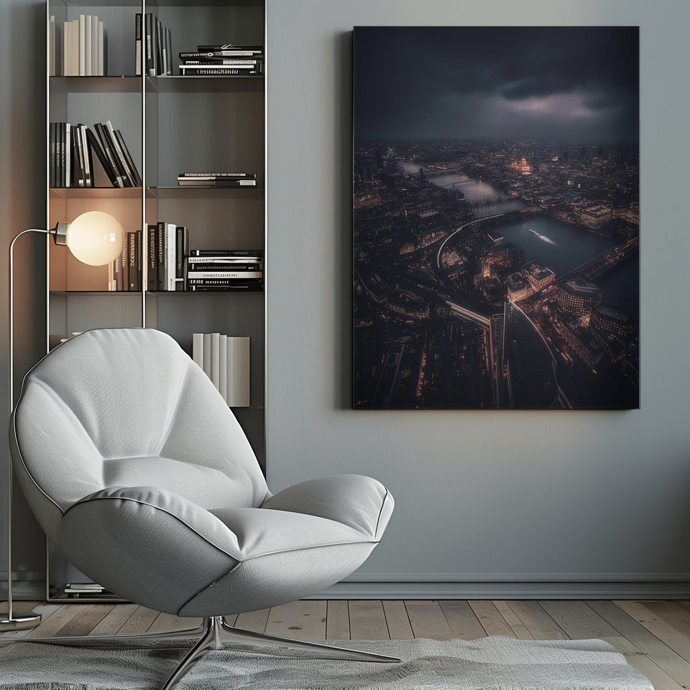 An aerial photograph of London at night from a high vantage point, overlooking the winding River Thames illuminated by the golden glow of city lights under a dark, dramatic, and cloudy sky. Wall Art