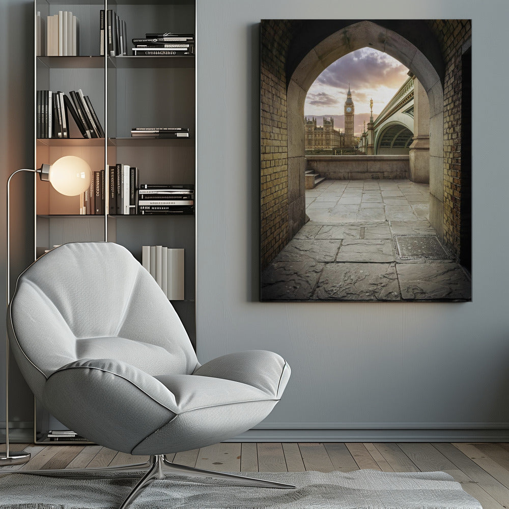 A scenic view of London's Big Ben clock tower and the Houses of Parliament as seen through a weathered stone archway. The foreground features a stone-paved walkway, and the background shows the iconic landmarks against a cloudy sunset sky with hues of purple and orange. Poster