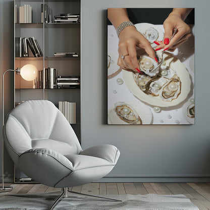 A close-up overhead shot of a woman's hands with vibrant red nails and elegant jewelry, using a fork to lift a large pearl from an oyster shell on a white plate. The plate and the surrounding white surface are adorned with numerous oysters filled with pearls of varying sizes, creating a luxurious and surreal scene. Print