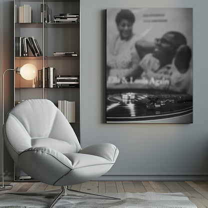 A black and white photograph focusing on a turntable's stylus resting on a spinning vinyl record. In the blurred background, the album cover for 'Ella & Louis Again' featuring Ella Fitzgerald and Louis Armstrong is visible. Poster