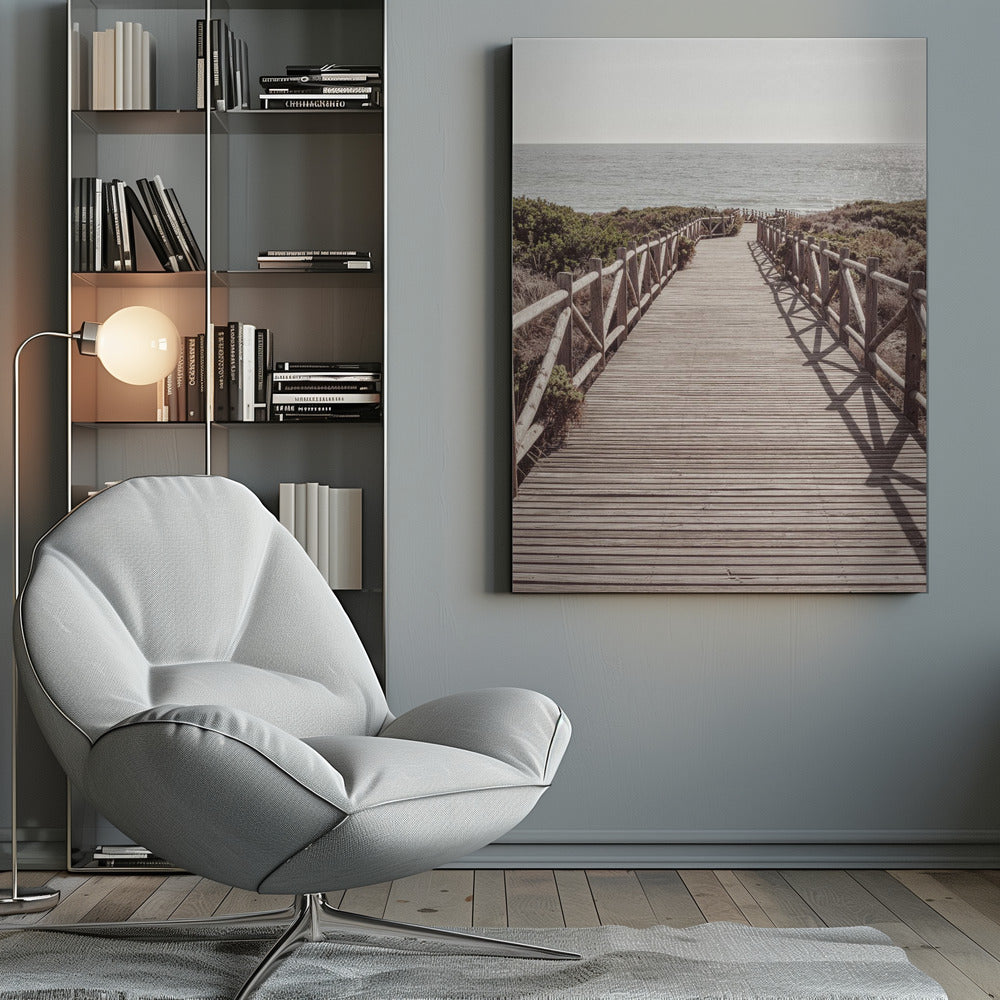 A long wooden boardwalk with rustic log railings leads the viewer's eye towards a calm, sunlit ocean under a hazy sky. Strong shadows from the railings fall across the path, creating a striped pattern. Poster