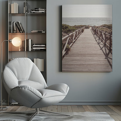 A long wooden boardwalk with rustic log railings leads the viewer's eye towards a calm, sunlit ocean under a hazy sky. Strong shadows from the railings fall across the path, creating a striped pattern. Poster