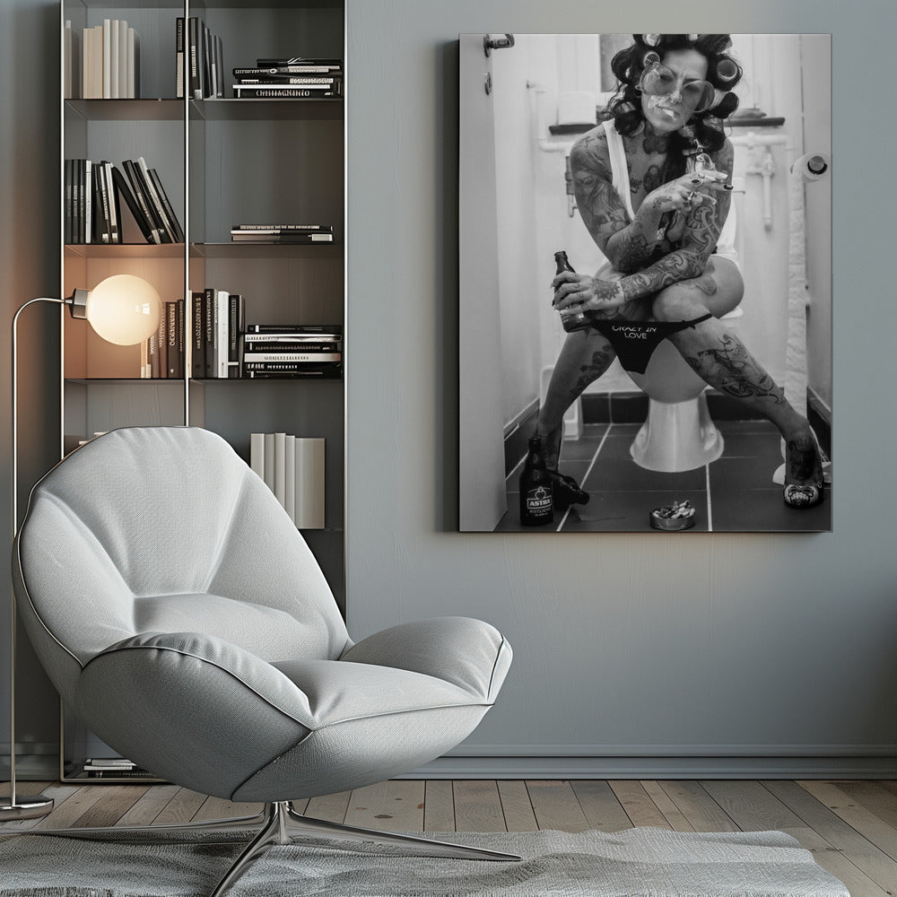 A black and white photo of a heavily tattooed woman with her hair in rollers sitting on a toilet. She wears large sunglasses, smokes a cigarette, holds a beer bottle, and has on black underwear that says 'CRAZY IN LOVE'. An ashtray and another beer bottle are on the floor. Artwork