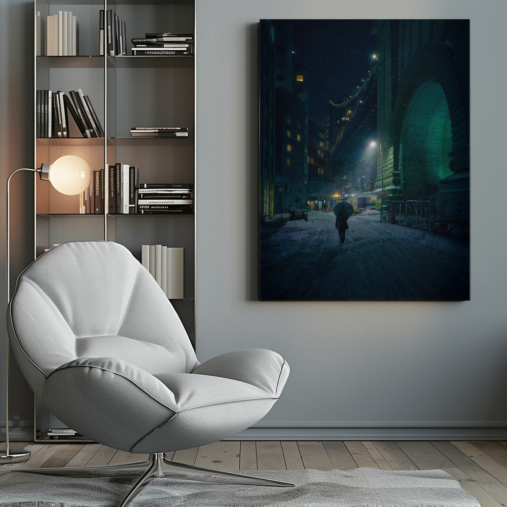 A lone person holding an umbrella walks down a snow-covered street at night, dwarfed by the massive, green-lit stone archway of the Brooklyn Bridge as snow falls around them. Print