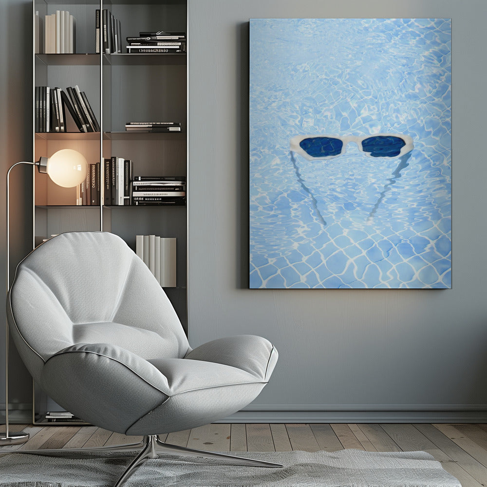 A pair of white-framed sunglasses with dark lenses floats on the surface of a bright blue swimming pool. The rippling water distorts the view of the tiled pool floor, and the sunglasses cast a faint shadow underneath. Print