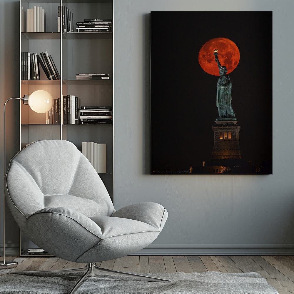 A striking night photograph of the Statue of Liberty perfectly silhouetted against a giant, vibrant red supermoon, which appears to be held aloft by the statue's torch against a deep black sky. Artwork