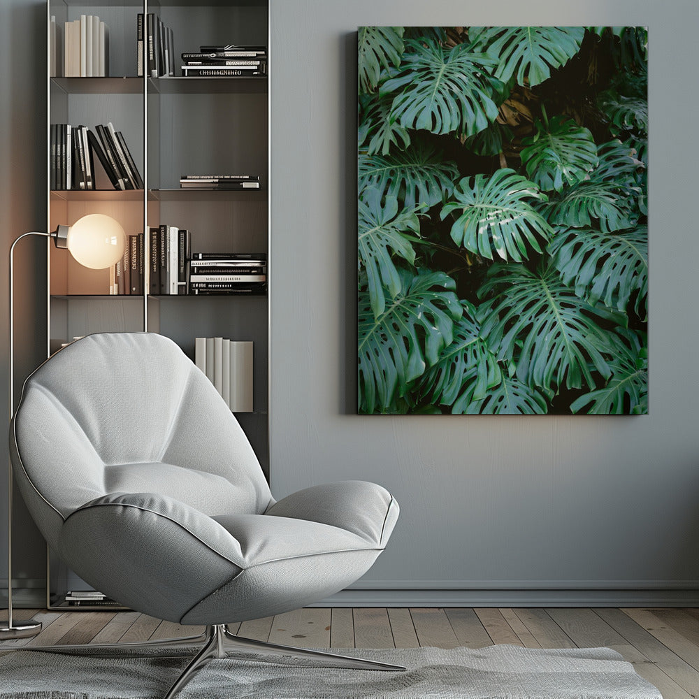 A close-up photograph of a dense cluster of large, vibrant green Monstera deliciosa leaves, also known as Swiss cheese plants. The leaves, with their characteristic splits and holes, fill the frame, creating a lush, textured pattern against a dark, shadowy background. Artwork