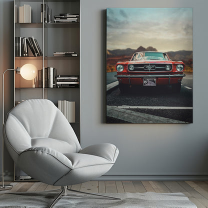 A low-angle, head-on shot of a vintage red Ford Mustang parked on an asphalt road. The iconic silver horse emblem is visible on the grille. In the background, a desert mountain range is blurred under a cloudy, muted sky. Poster