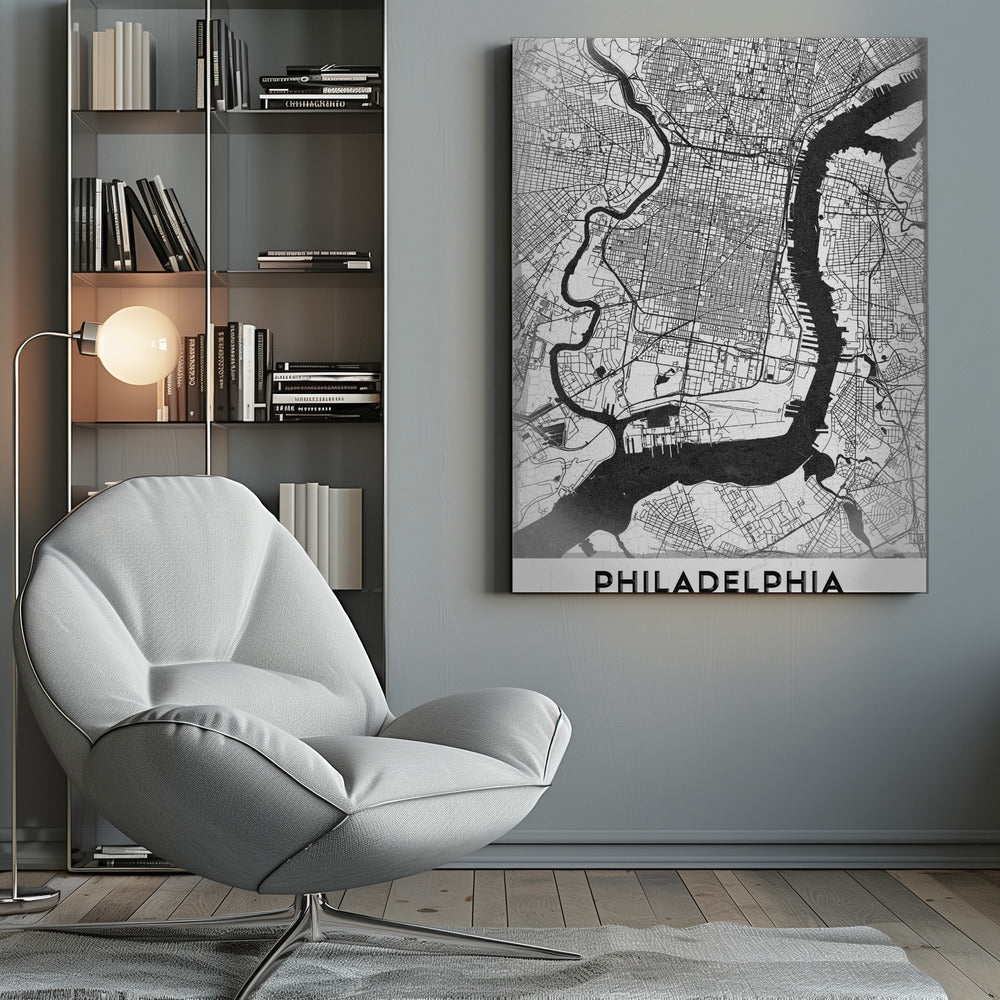 A modern black and white framed poster of a city map of Philadelphia. The map details the street grid, with the Schuylkill and Delaware rivers prominently featured in solid black. The word 'PHILADELPHIA' is printed in a bold, black sans-serif font at the bottom. Artwork
