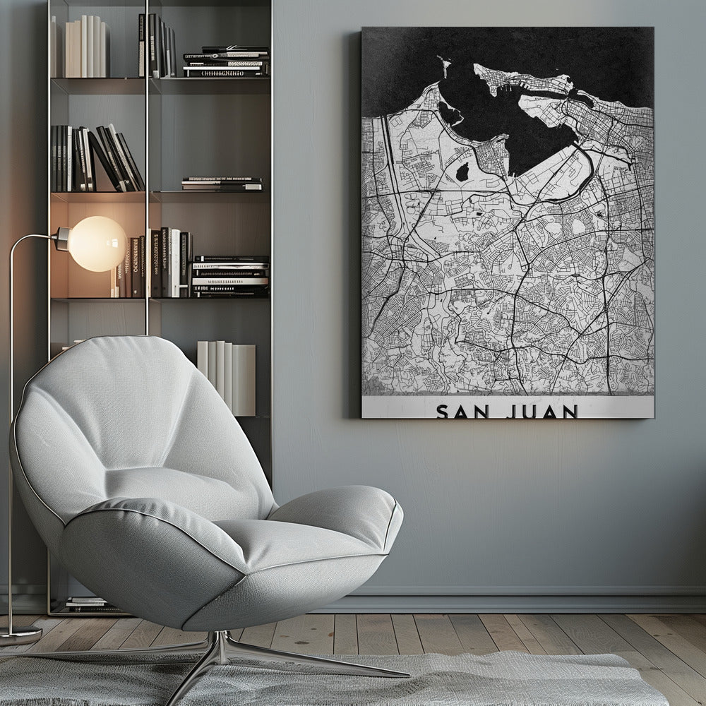 A minimalist black and white map of San Juan, Puerto Rico, shown as a framed poster. The land is depicted in white with intricate black lines for roads and streets, while the surrounding water is a solid, textured black. A white banner at the bottom features the text 'SAN JUAN' in a bold, black, sans-serif font. Artwork
