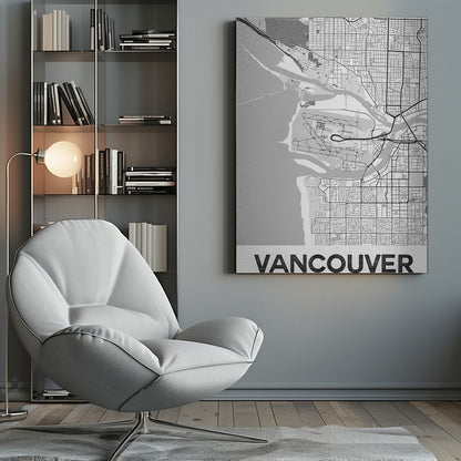A modern, black and white framed art print of a city map of Vancouver. The map features a stylized layout of roads, rivers, and the coastline, including what appears to be an airport. The word 'VANCOUVER' is displayed in bold, capital letters at the bottom. Poster