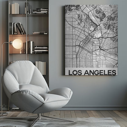A modern, framed black and white map of Los Angeles. The detailed illustration features a dense grid of city streets, winding highways, rivers, and topographic details of hills. A white banner at the bottom displays the words 'LOS ANGELES' in a bold, black, textured font. Poster