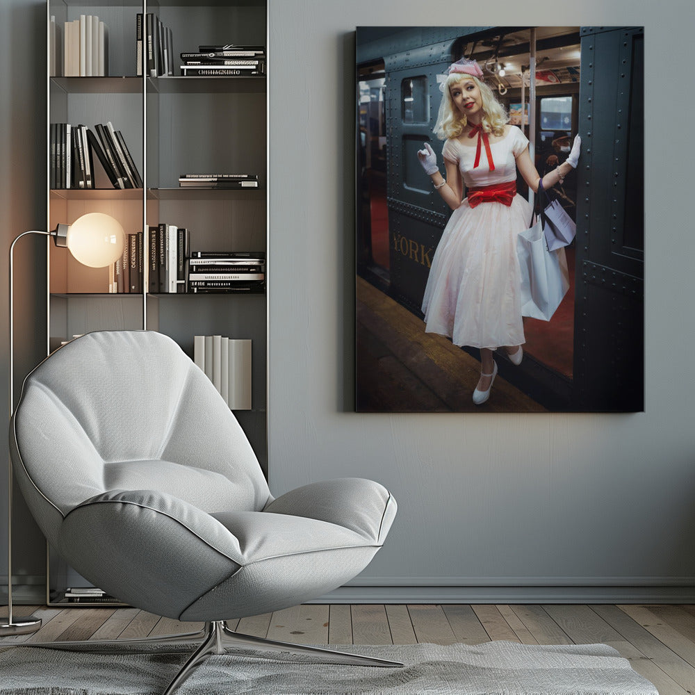 A full-length portrait of a young woman with blonde hair dressed in 1950s-style fashion, including a light pink dress with a bright red sash, a pink veiled hat, and white gloves. She smiles as she steps out of a dark, vintage train car onto a platform, holding shopping bags. Poster