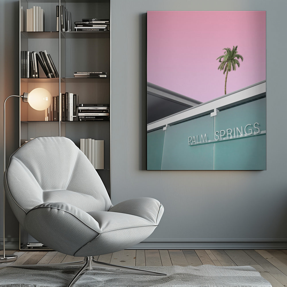 A low-angle shot of a modern building with a frosted teal glass facade and a white neon sign that reads 'PALM SPRINGS'. Above the building, a single tall palm tree stands against a solid, vibrant pink sky, creating a minimalist and stylized composition. Decor