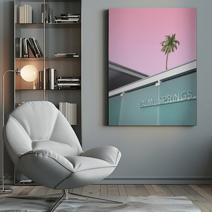 A low-angle shot of a modern building with a frosted teal glass facade and a white neon sign that reads 'PALM SPRINGS'. Above the building, a single tall palm tree stands against a solid, vibrant pink sky, creating a minimalist and stylized composition. Decor
