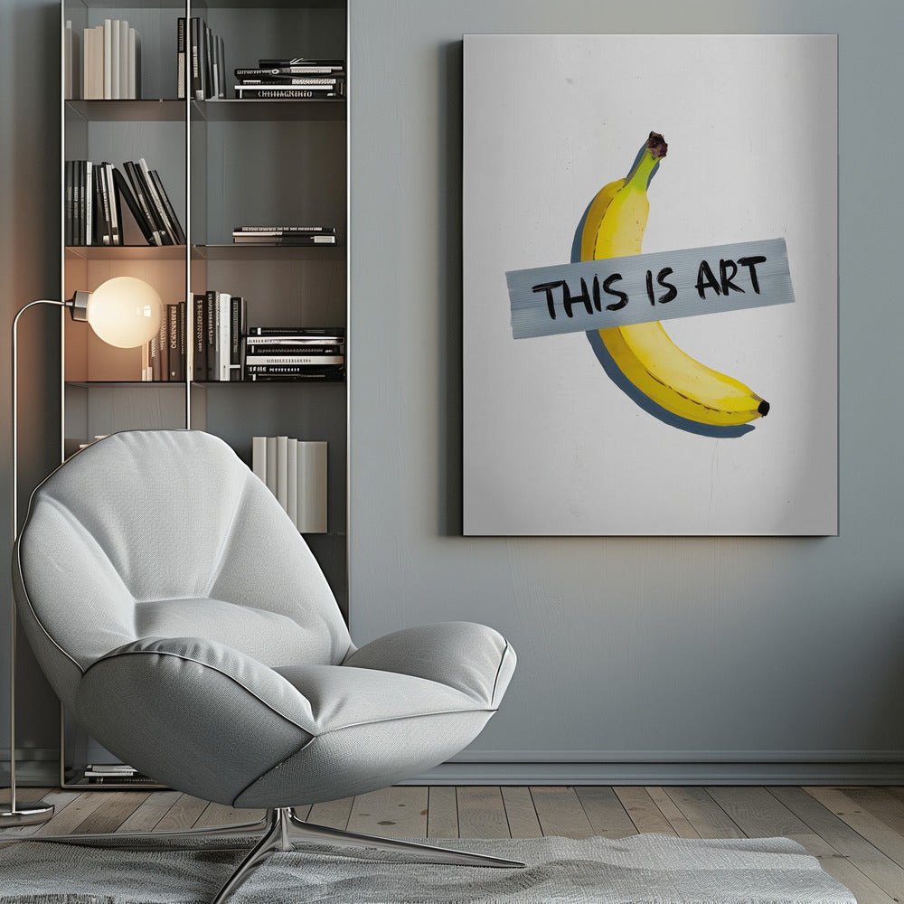 A framed artwork depicting a single yellow banana taped to a white wall with a grey strip of tape that reads 'THIS IS ART' in black marker-style font. Artwork