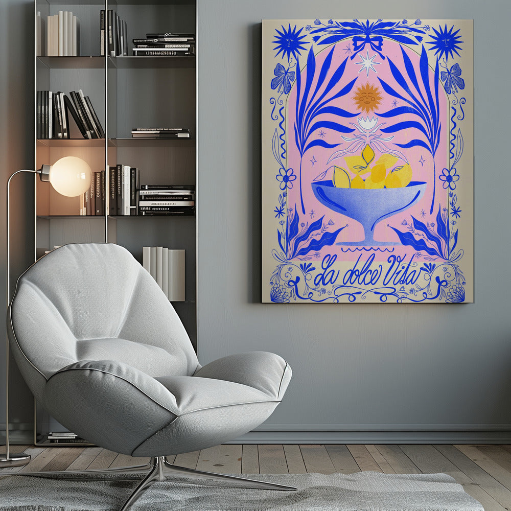 A vibrant, symmetrical illustration featuring a blue bowl of yellow lemons set against a pink arched background. The scene is framed by elaborate blue botanicals, flowers, butterflies, and celestial symbols like suns with faces. At the bottom, the phrase 'La dolce Vita' is written in elegant blue script. Decor
