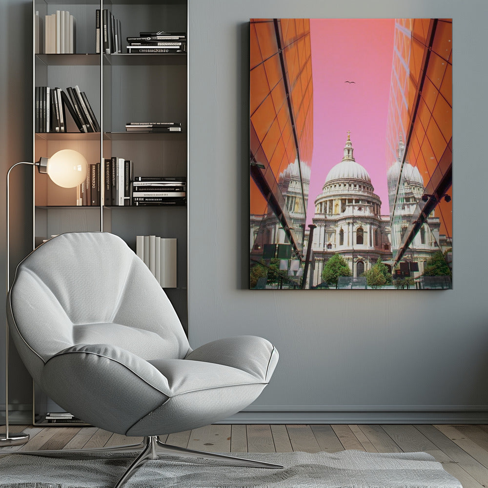 A low-angle, surrealist photograph of a classic white dome cathedral, framed perfectly between two modern orange glass buildings. The cathedral's reflection is visible on the buildings' surfaces against a vibrant, solid pink sky with a lone bird in flight. Poster