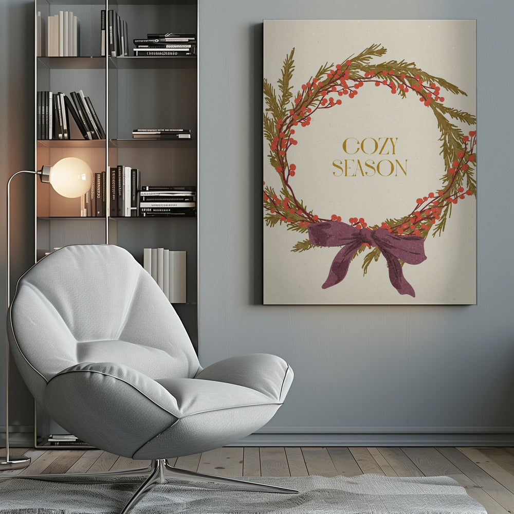 A vintage-style illustration of a festive wreath made of green boughs and red berries, tied with a large purple bow at the bottom. The text 'COZY SEASON' is written in gold inside the wreath on a cream-colored background, all enclosed in a thin black frame. Wall Art