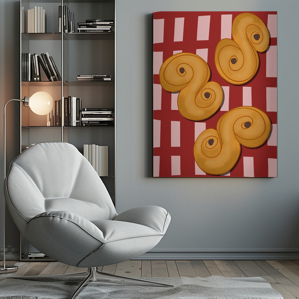 A vibrant illustration of three golden-yellow S-shaped pastries, resembling Swedish saffron buns, resting on a red and pink checkered tablecloth. The artwork is presented within a black frame. Decor