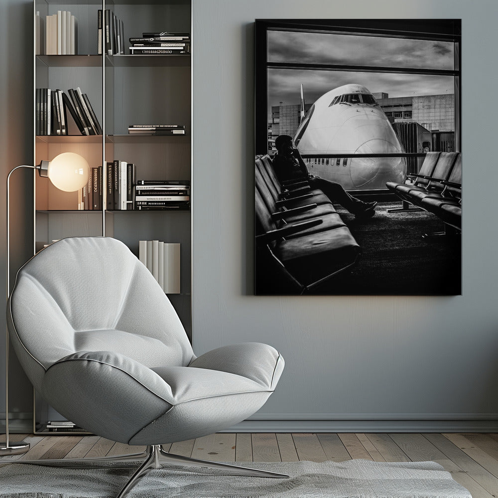 A dramatic black and white photograph of a silhouetted person sitting in an airport departure lounge, waiting for their flight. Through the large window, the enormous nose of a Boeing 747 jumbo jet is visible up close, dominating the view under a cloudy sky. Artwork