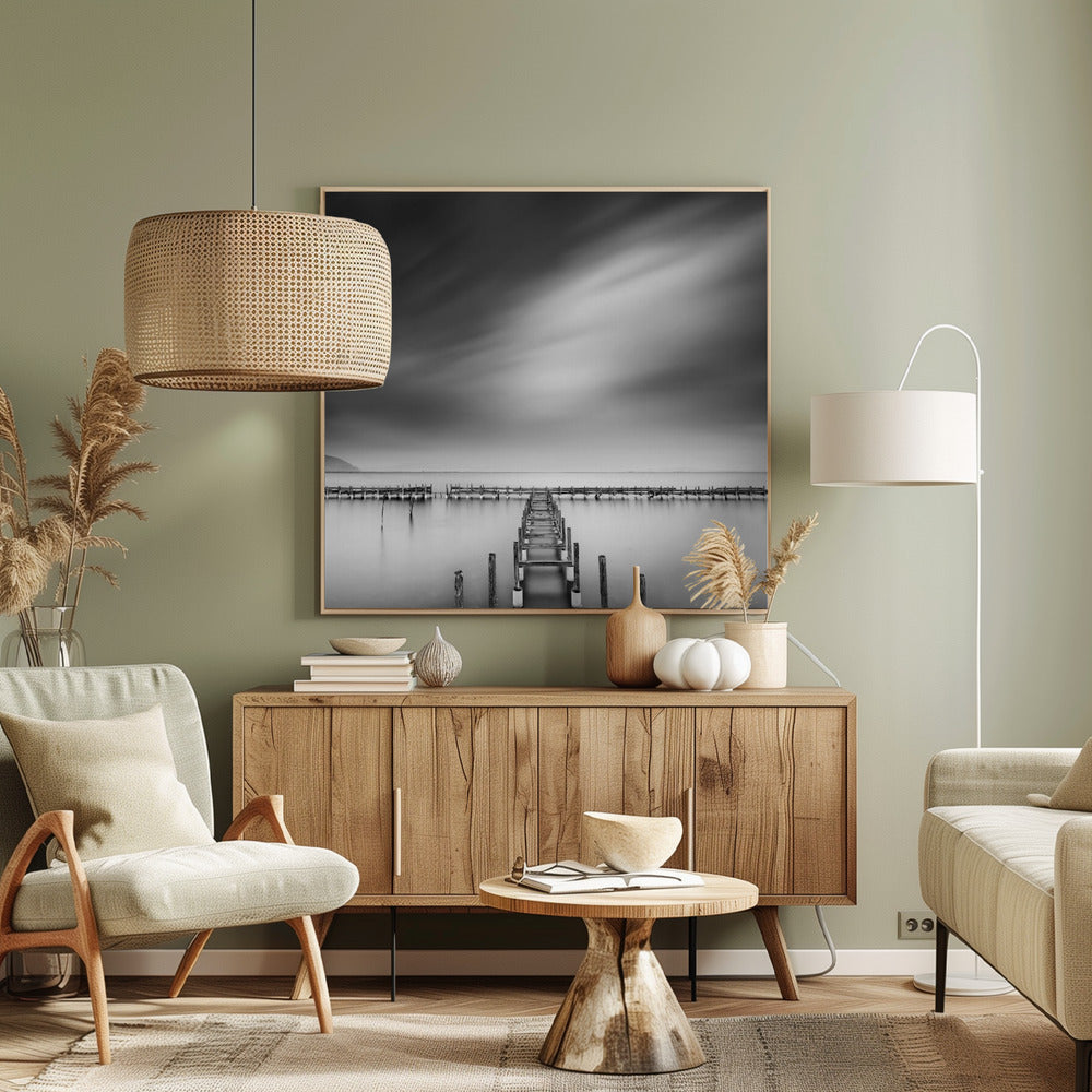 A framed, square black and white long-exposure photograph of a dilapidated wooden pier extending into calm, misty water. The sky is filled with soft, streaked clouds, creating a serene and melancholic mood. Wall Art