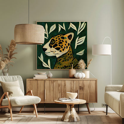 A stylized painting of a jaguar's head and neck in profile against a dark green background. The jaguar has yellow and orange fur with black spots. The background is adorned with scattered, simple, off-white leaf illustrations. The artwork has a textured, folk-art feel and is enclosed in a light wood frame. Decor