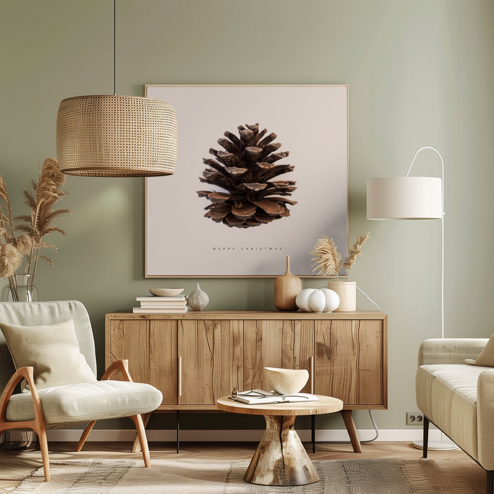 A minimalist art print featuring a single brown pinecone centered on an off-white background. The words 'MERRY CHRISTMAS' are printed in a simple, spaced-out font below the pinecone. The entire image is enclosed in a light wood frame. Artwork