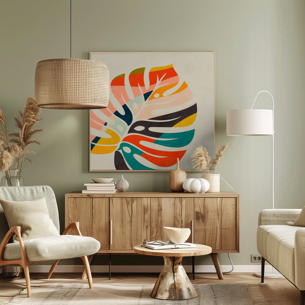 A framed abstract artwork featuring a stylized Monstera leaf. The leaf is composed of various colorful blocks and stripes in orange, teal, pink, and dark blue, set against a beige background. Print