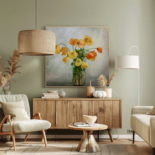 A soft-focus still life photograph of a bouquet of yellow and orange poppies in a clear glass jar, set against a delicate, light green textured background, all enclosed in a light wood frame. Print