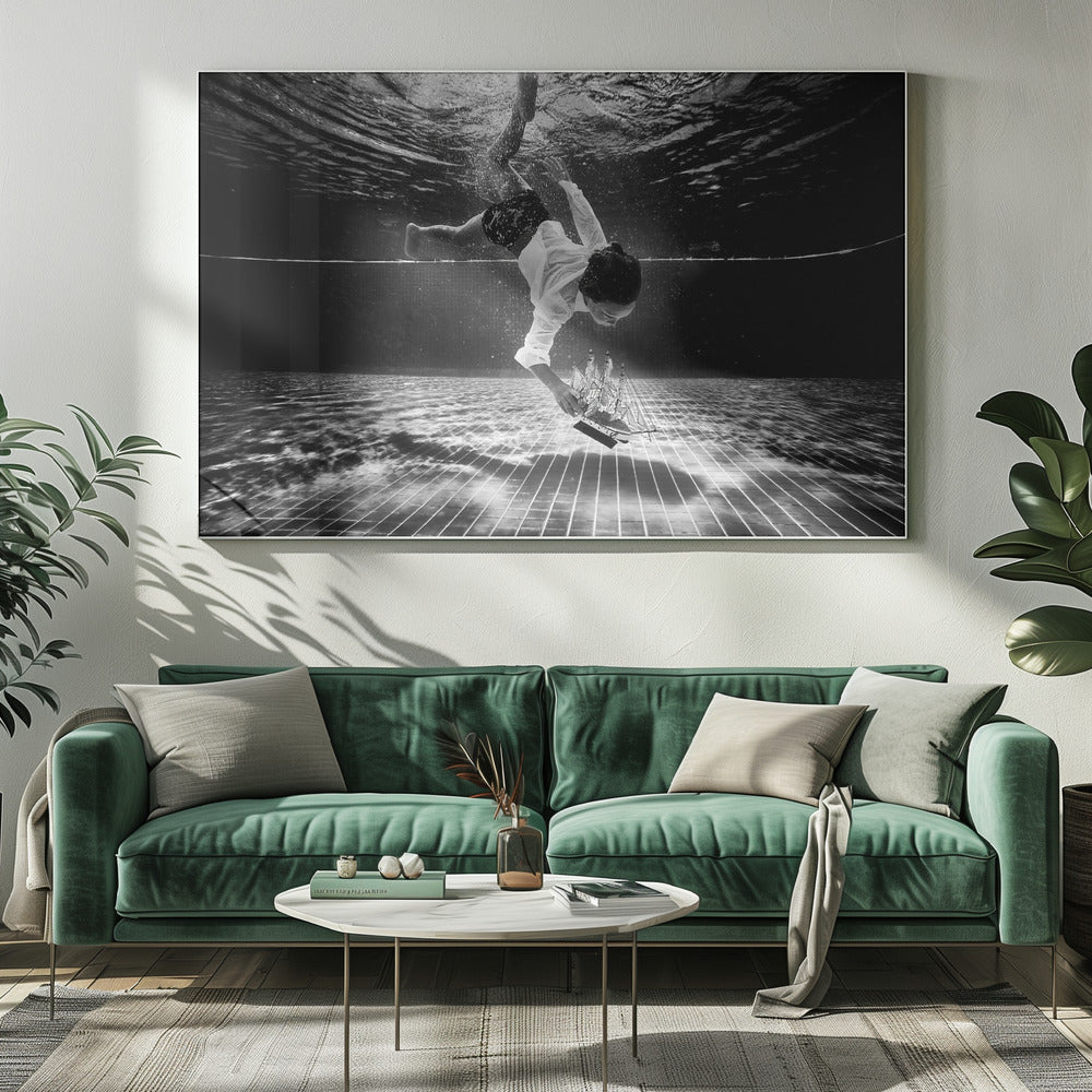 A surreal black and white underwater photograph of a child in a white shirt and shorts diving towards the bottom of a tiled pool to retrieve a miniature model of a sailing ship. Artwork