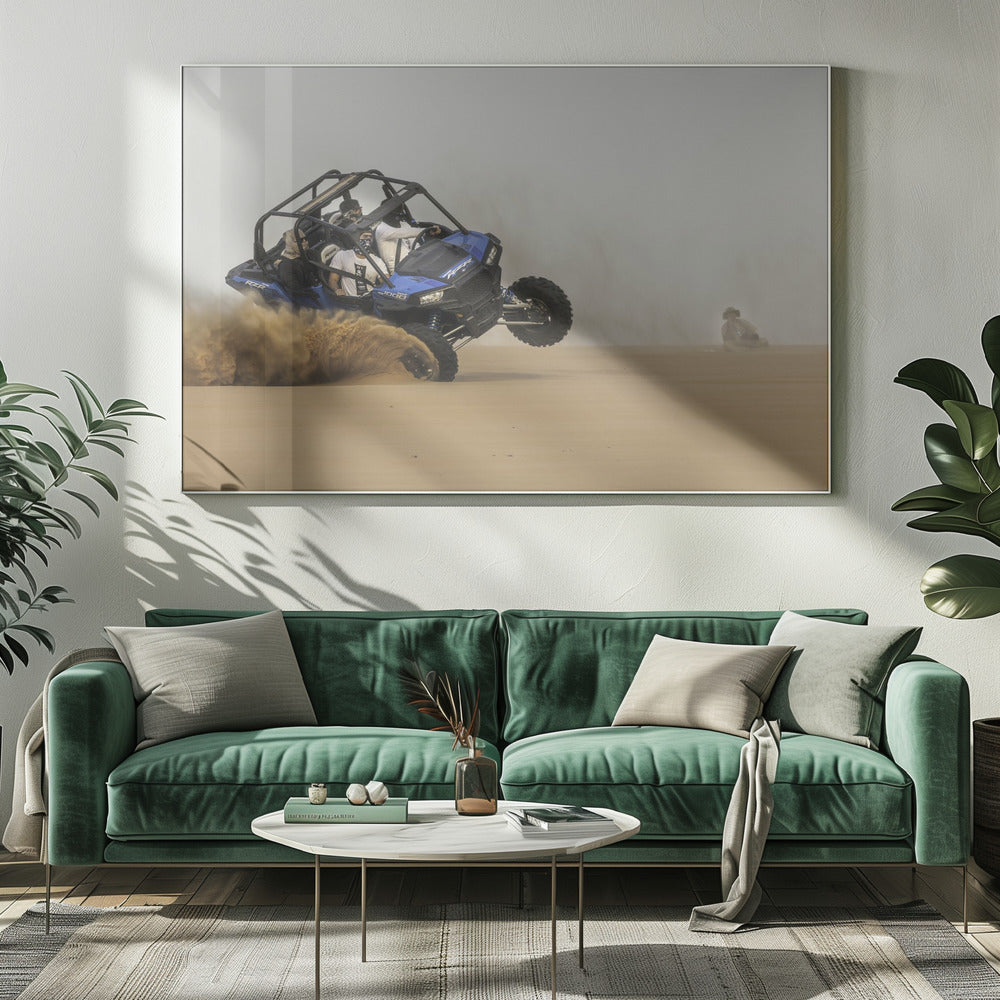 A framed action shot of a blue dune buggy with several passengers making a sharp turn in the desert, kicking up a large cloud of sand and lifting its front wheel off the ground. Wall Art