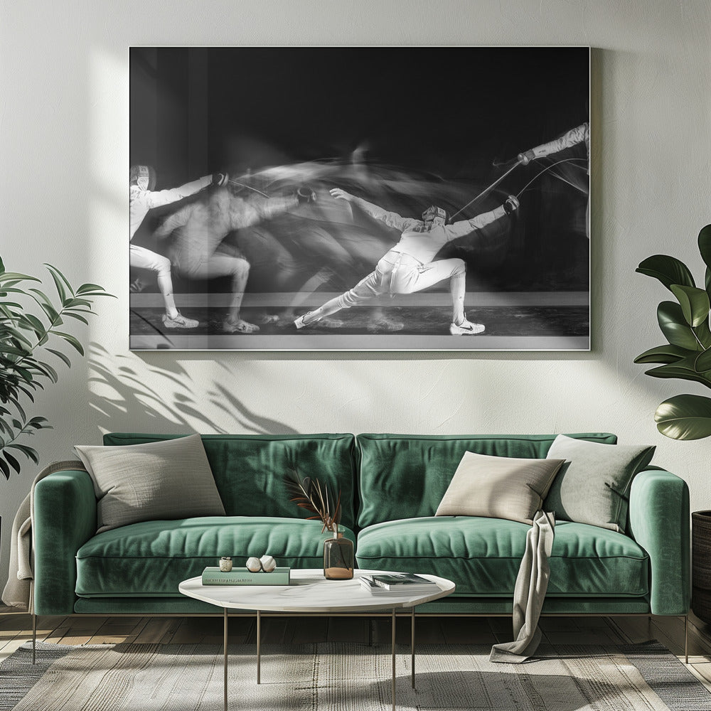 A framed, dramatic black and white photograph using long exposure to capture a fencer in motion. The fencer, in full white gear, lunges forward, their form crisp at the end of the movement while a ghostly blur trails behind, illustrating their rapid advance against a black background. Decor