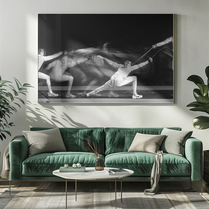 A framed, dramatic black and white photograph using long exposure to capture a fencer in motion. The fencer, in full white gear, lunges forward, their form crisp at the end of the movement while a ghostly blur trails behind, illustrating their rapid advance against a black background. Decor