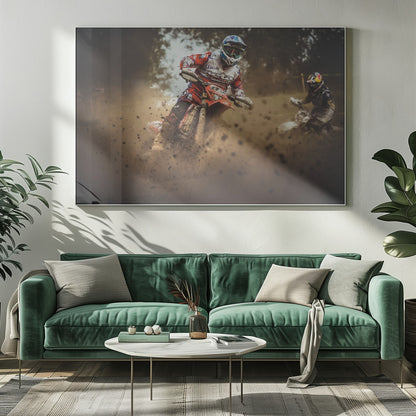 An action shot of a motocross rider in red, white, and blue gear, speeding through a dusty turn on a dirt track, kicking up a large cloud of mud and debris. Another racer is visible in the background. The image is presented within a silver frame. Print
