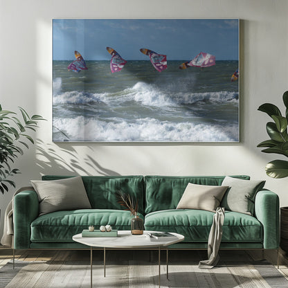 A composite, silver-framed photograph capturing the four stages of a windsurfer's impressive jump over choppy, white-capped ocean waves under a partly cloudy blue sky. Print