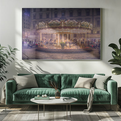 A beautifully illuminated vintage carousel with ornate horses in a European cobblestone plaza at night. The carousel is the central focus, glowing with warm lights against a backdrop of historic buildings and a starry purple sky. Poster