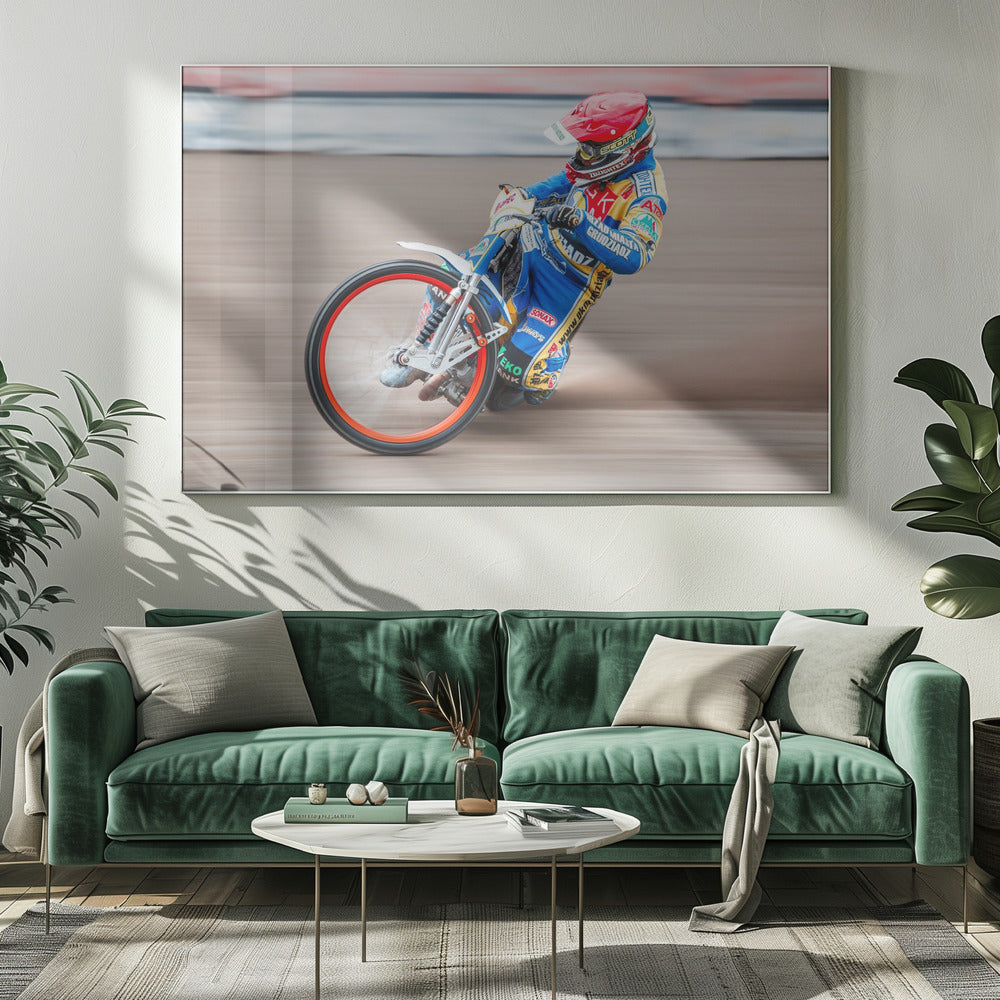 A speedway motorcycle racer in a blue and yellow suit with a red helmet leans sharply into a turn on a dirt track, with motion blur in the background conveying a sense of high speed. Print