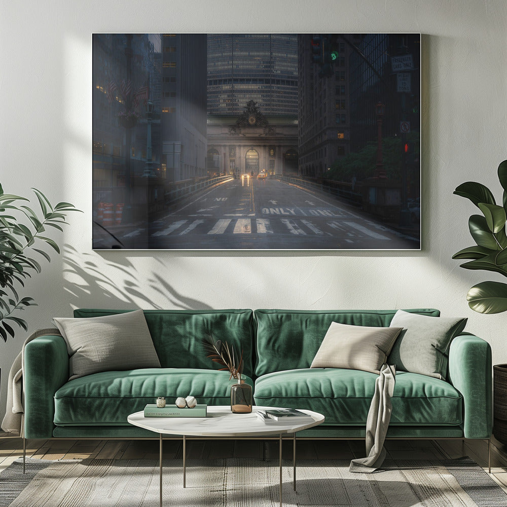 A moody photograph of a wet city street at dusk, leading towards the illuminated facade of Grand Central Terminal in New York City, which is framed by tall, modern skyscrapers. Decor