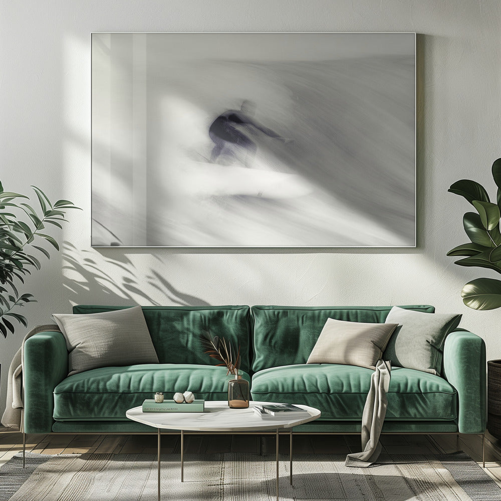 An artistic black and white photograph using motion blur to capture a surfer in a dynamic, fluid pose on a wave. The slow shutter speed creates a sense of speed and abstract movement, with the surfer's dark wetsuit contrasting against the white, streaked water. The image is presented in a silver frame. Decor
