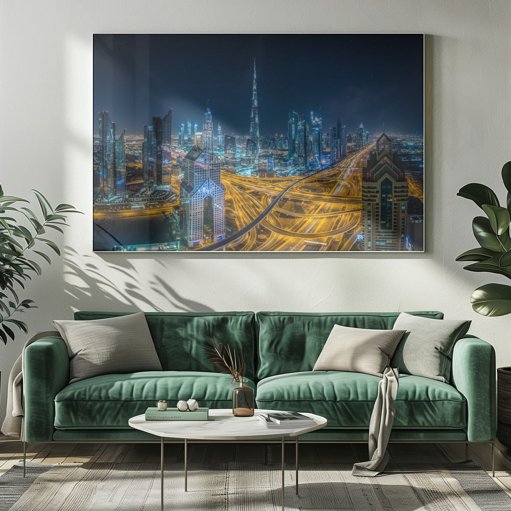 A vibrant aerial photograph of the Dubai skyline at night, with the iconic Burj Khalifa towering in the center. A complex web of brightly lit highways with light trails from traffic dominates the foreground, weaving between modern skyscrapers under a starry night sky. Decor