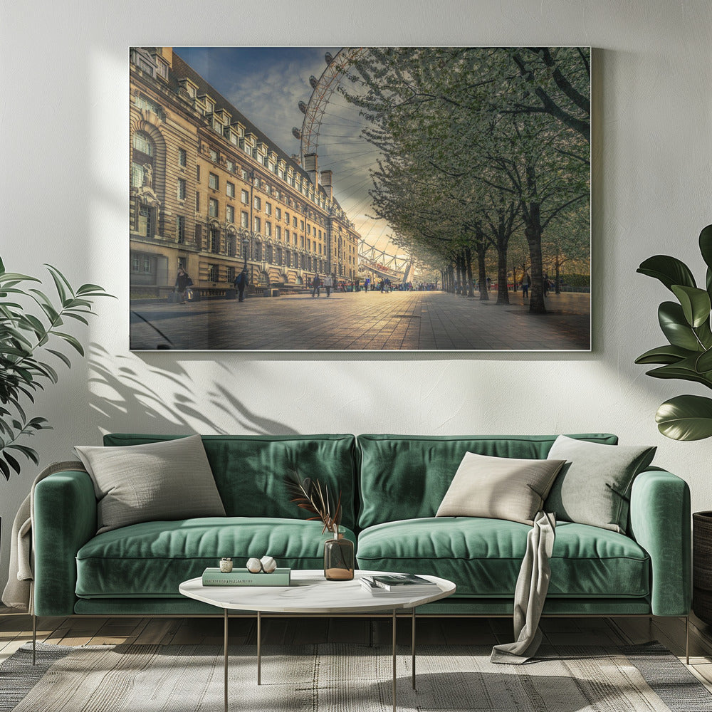 A scenic view of London's South Bank at sunset, with the London Eye visible in the background, a grand historic building on the left, and a row of white blossoming trees lining the sunlit promenade on the right. Wall Art