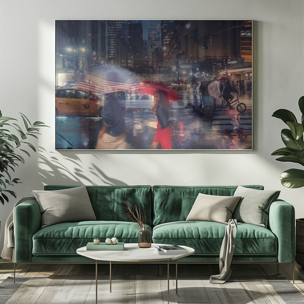 An artistic motion-blur photograph of a rainy night on East 42nd Street in New York City. Pedestrians with umbrellas, one with an American flag design and another bright red, cross the wet street as city lights and a yellow taxi reflect on the pavement, creating a vibrant, impressionistic scene within a silver frame. Decor