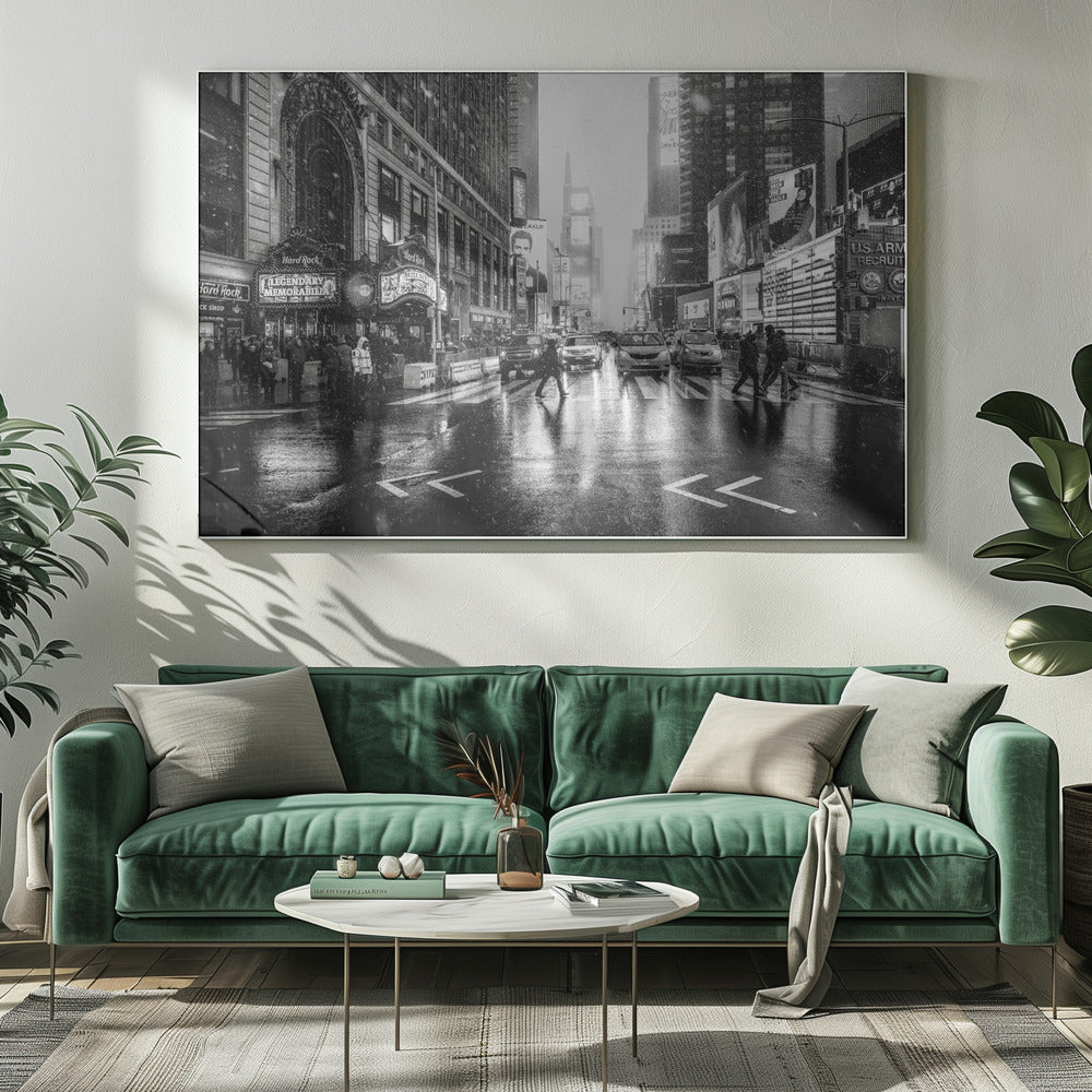A moody black and white photograph of a snowy day in New York City's Times Square. The wet streets reflect the bright lights of the surrounding buildings and billboards as pedestrians cross the street and cars wait in traffic. Artwork