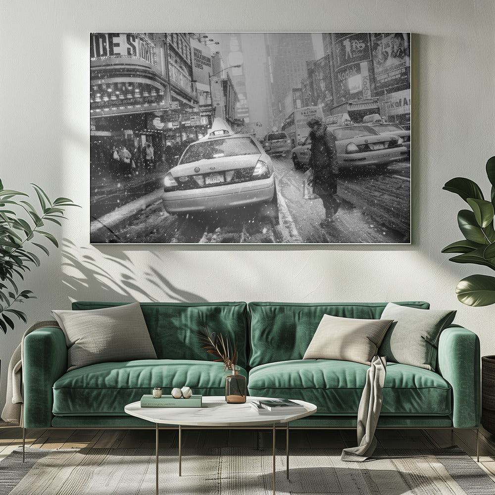 A black and white photograph of a bustling New York City street during a snowstorm. A person in a heavy winter coat crosses the street in front of a line of yellow cabs, with the bright lights of Times Square billboards glowing softly in the background through the falling snow. Print
